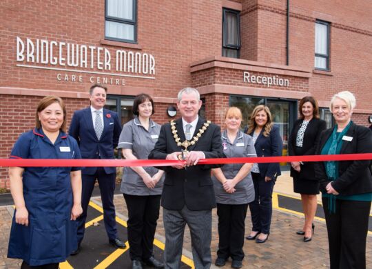 Cllr-John-Mullen-cutting-the-red-ribbon-to-open-Bridgewater-Manor-with-the-New-Care-team